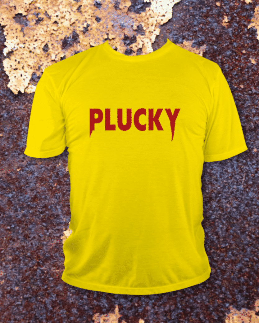 Yellow T-shirt printed with red PLUCKY lettering, photographed against rusted metal